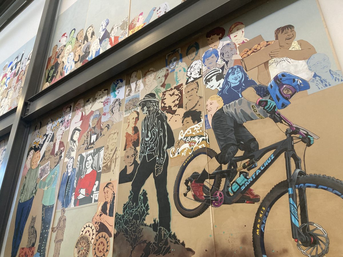 A close-up of the mural showcasing a diverse group of women from different backgrounds, with expressive colors, bold outlines, and comic book-style speech bubbles.