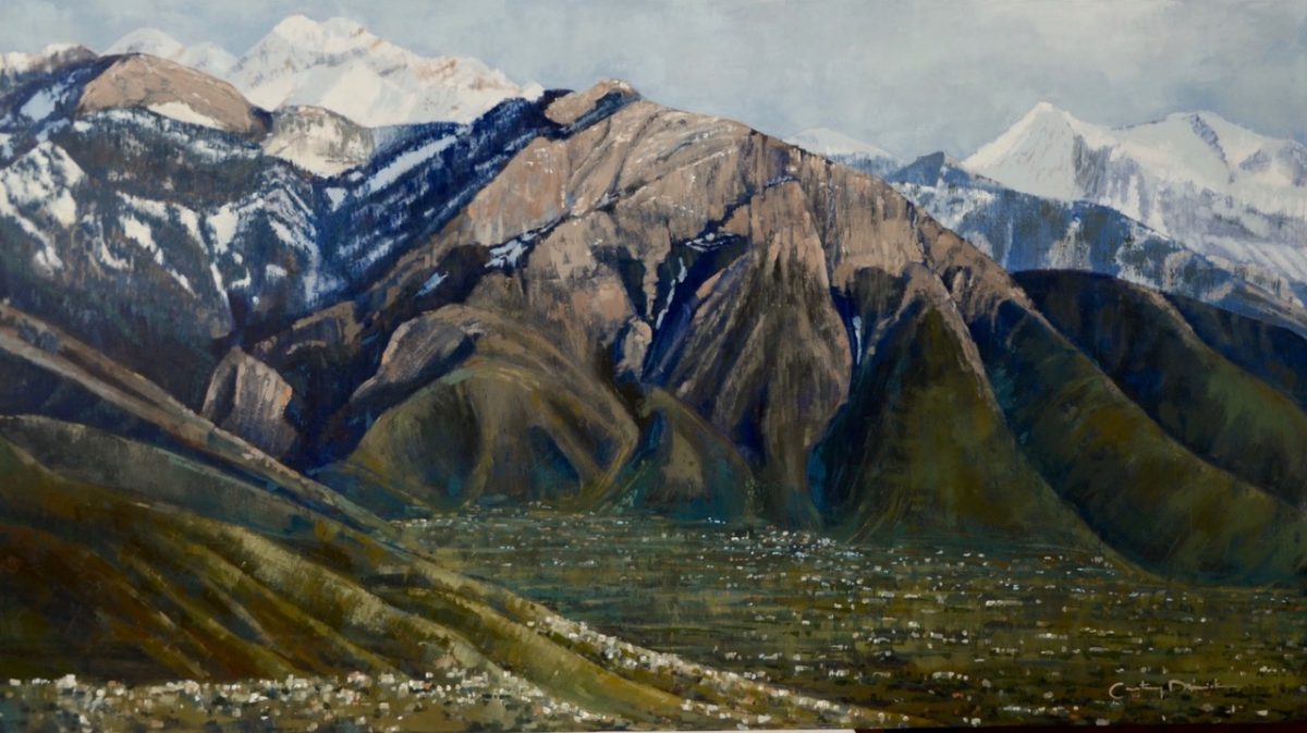 A landscape painting of Mount Olympus, Utah, featuring rugged peaks with snow-covered summits and green foothills below. The painting captures the contrast between light and shadow on the mountain slopes, with a valley and small buildings visible in the foreground.