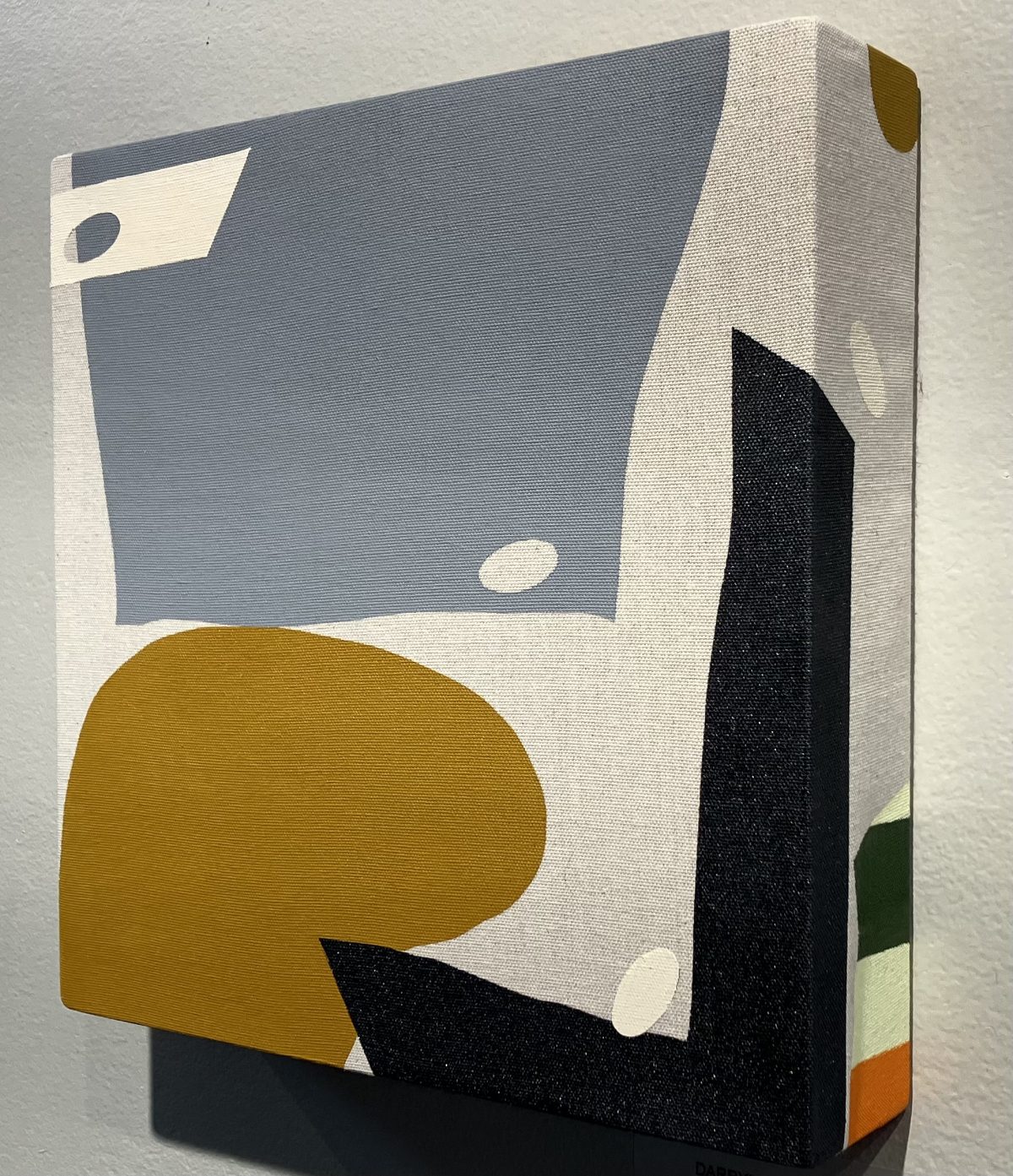 Small geometric abstract painting on canvas with muted colors, including mustard yellow, gray, and black, featuring simple shapes with crisp lines and textured edges.