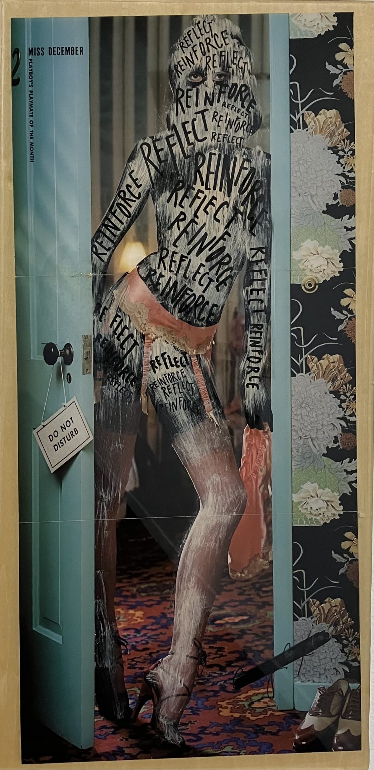 A Playboy model in lingerie is overlaid with black paint and the repeated words “reflect” and “reinforce” across her body. She stands in a doorway with a “Do Not Disturb” sign hanging from the knob and vintage wallpaper in the background.