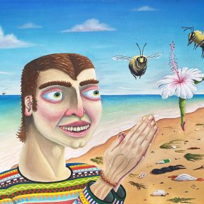 Playful self-portrait of Trevor Dahl on a beach, smiling at two large bees approaching a flower with a ballerina-like stem, surrounded by beach litter and offshore oil rigs in the distance.