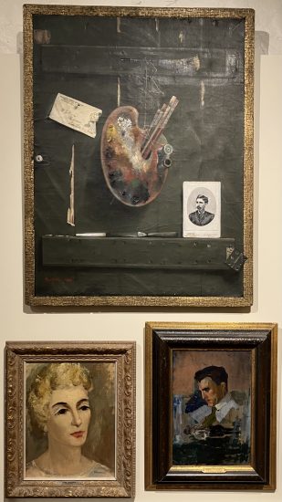 A trompe l’oeil painting of an artist’s palette and vintage photograph on a wooden shelf, flanked by two expressive portraits.