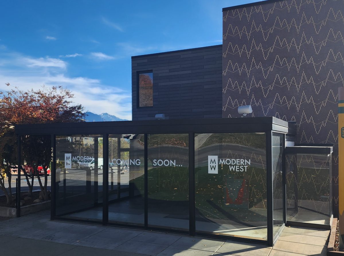 exterior view of Modern West’s new glass-fronted gallery pavilion on South Temple, with mountains in the distance